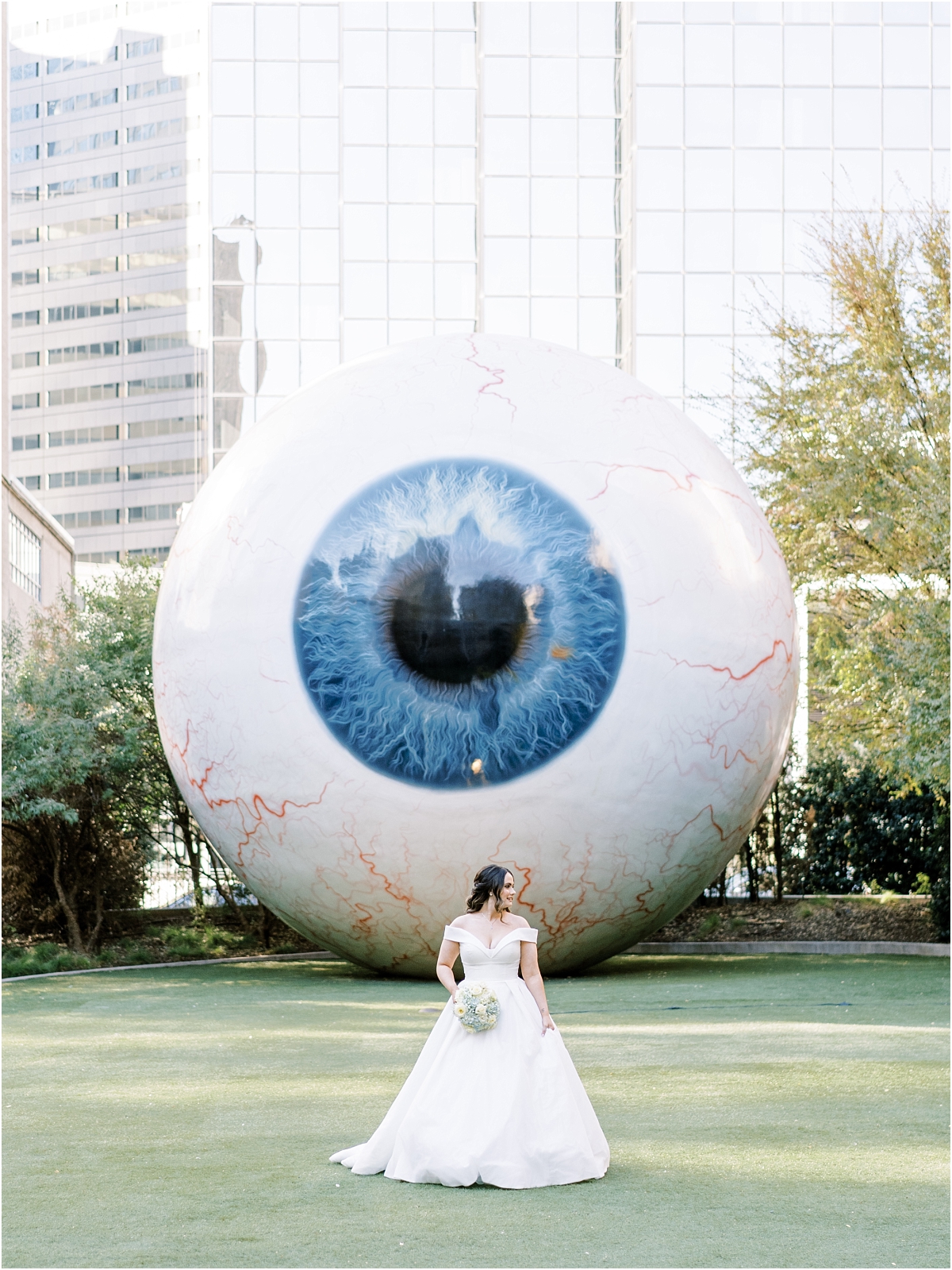 bride standing in front of the Eye downtown Dallas. 