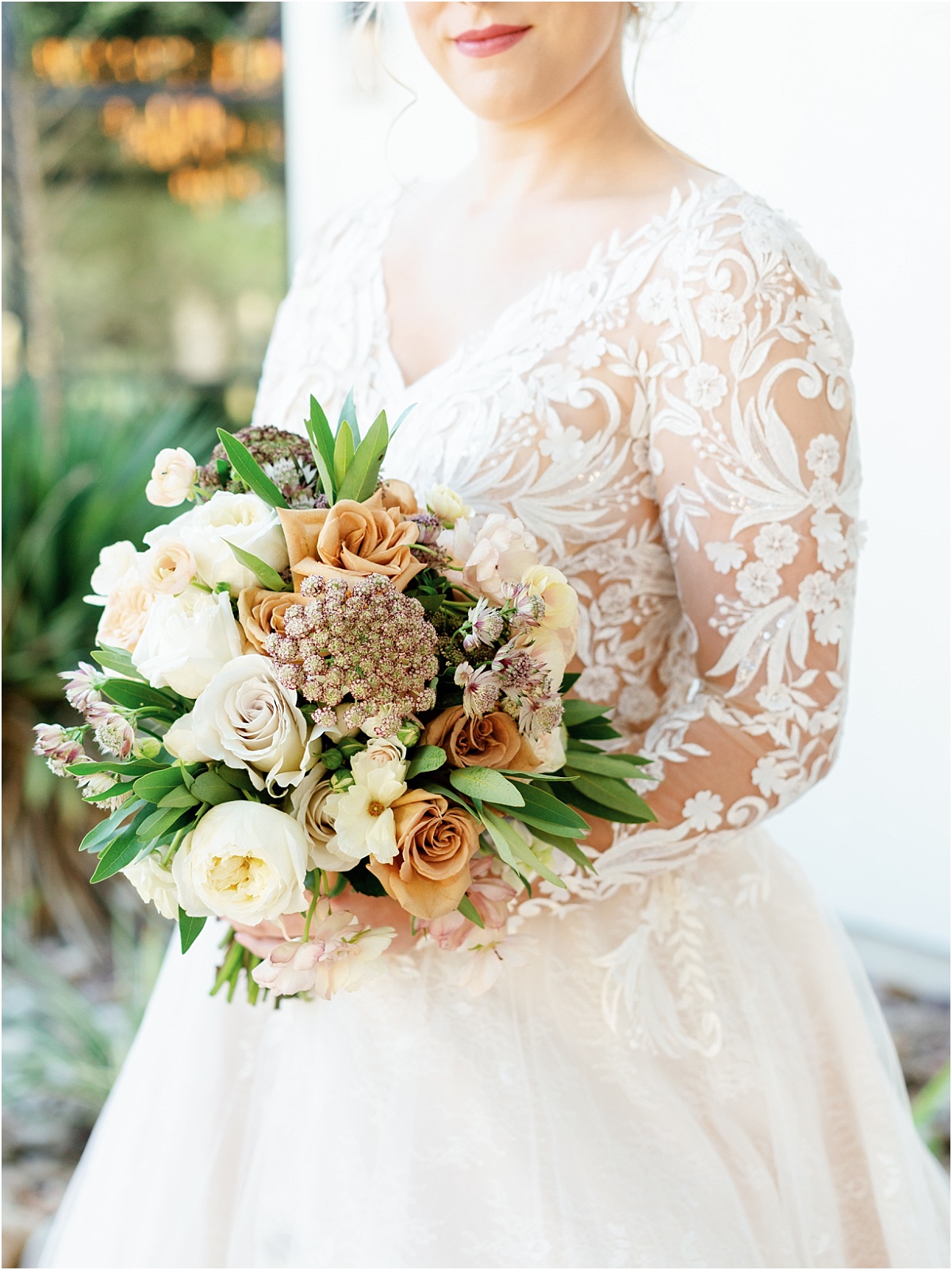 bride-holding-fall-colored-floral-bouquet
