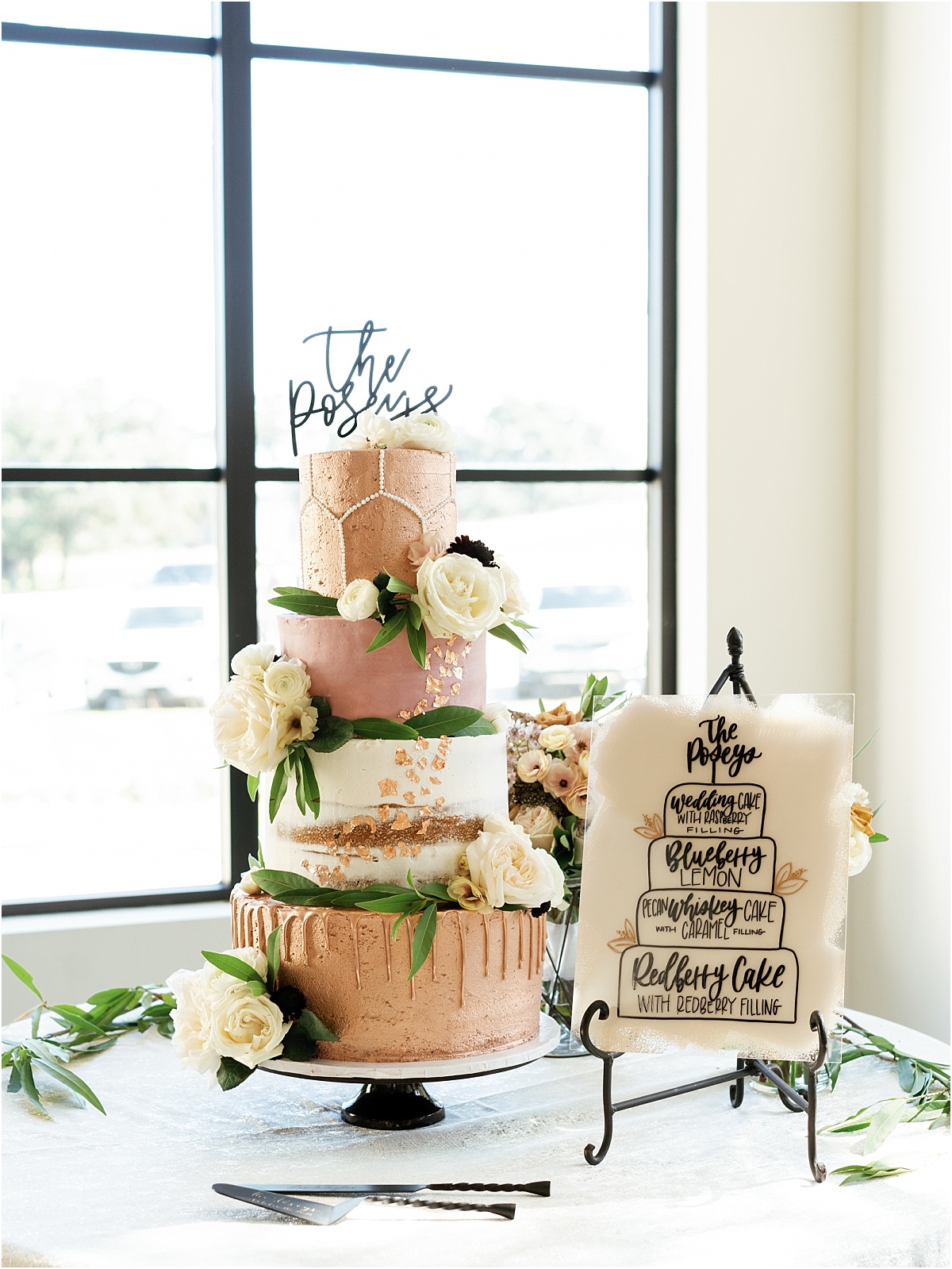 four-tier-oink-and-cream-wedding-cake-with-white-roses