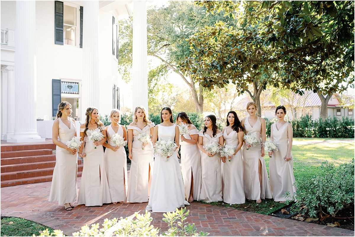 bride with bridesmaids in the front of woodbine mansion