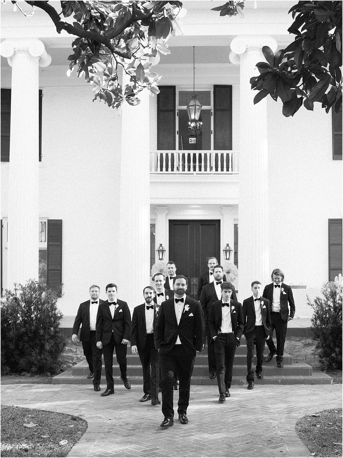 groom with groomsmen on the front porch of Woodbine Mansion