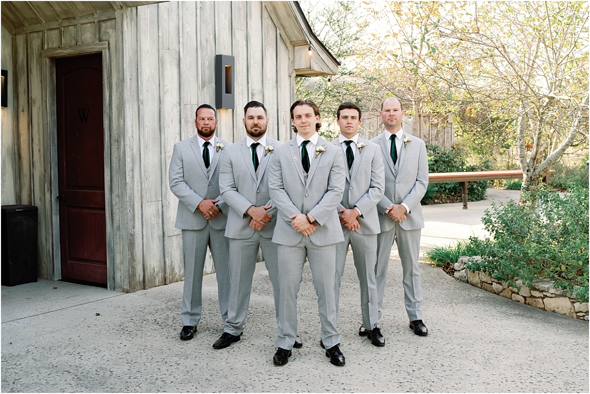 groom-posed-with-groomsmen-in-gray-suits