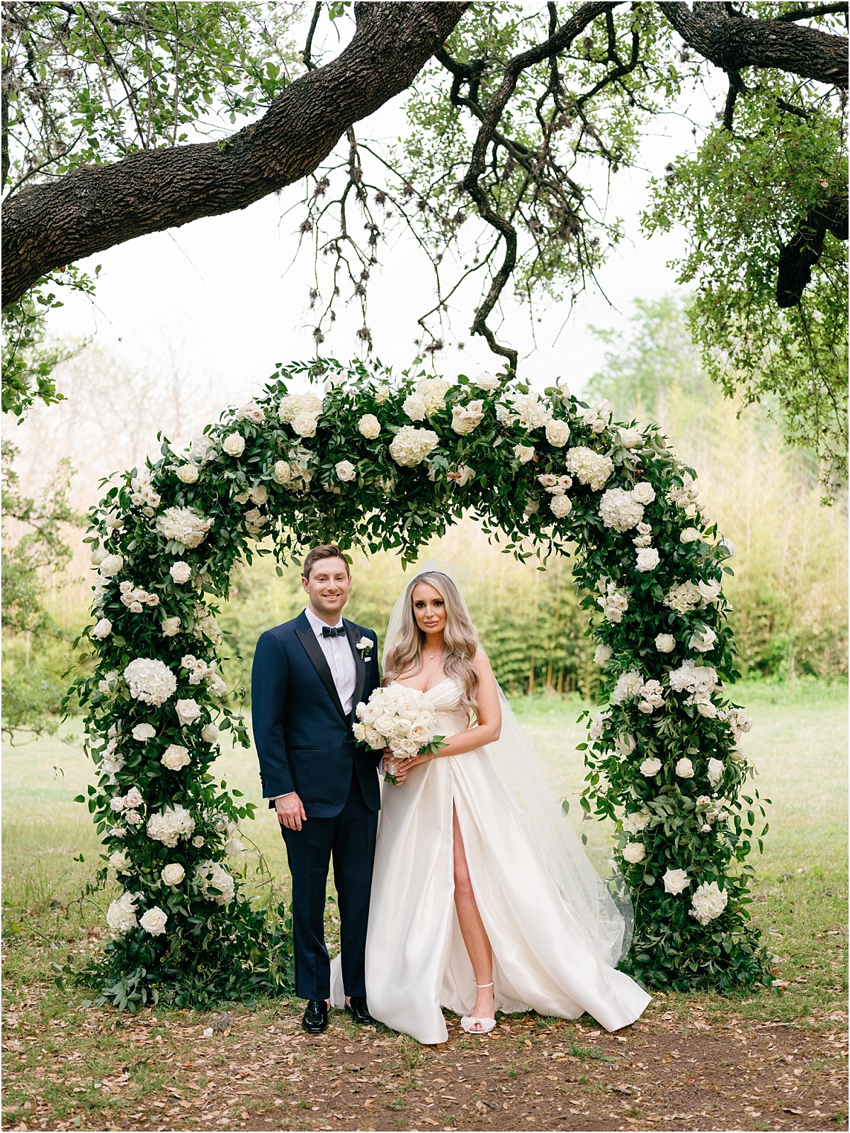 Bride and Groom standing in front of ceremony arch at Mattie's Austin wedding.