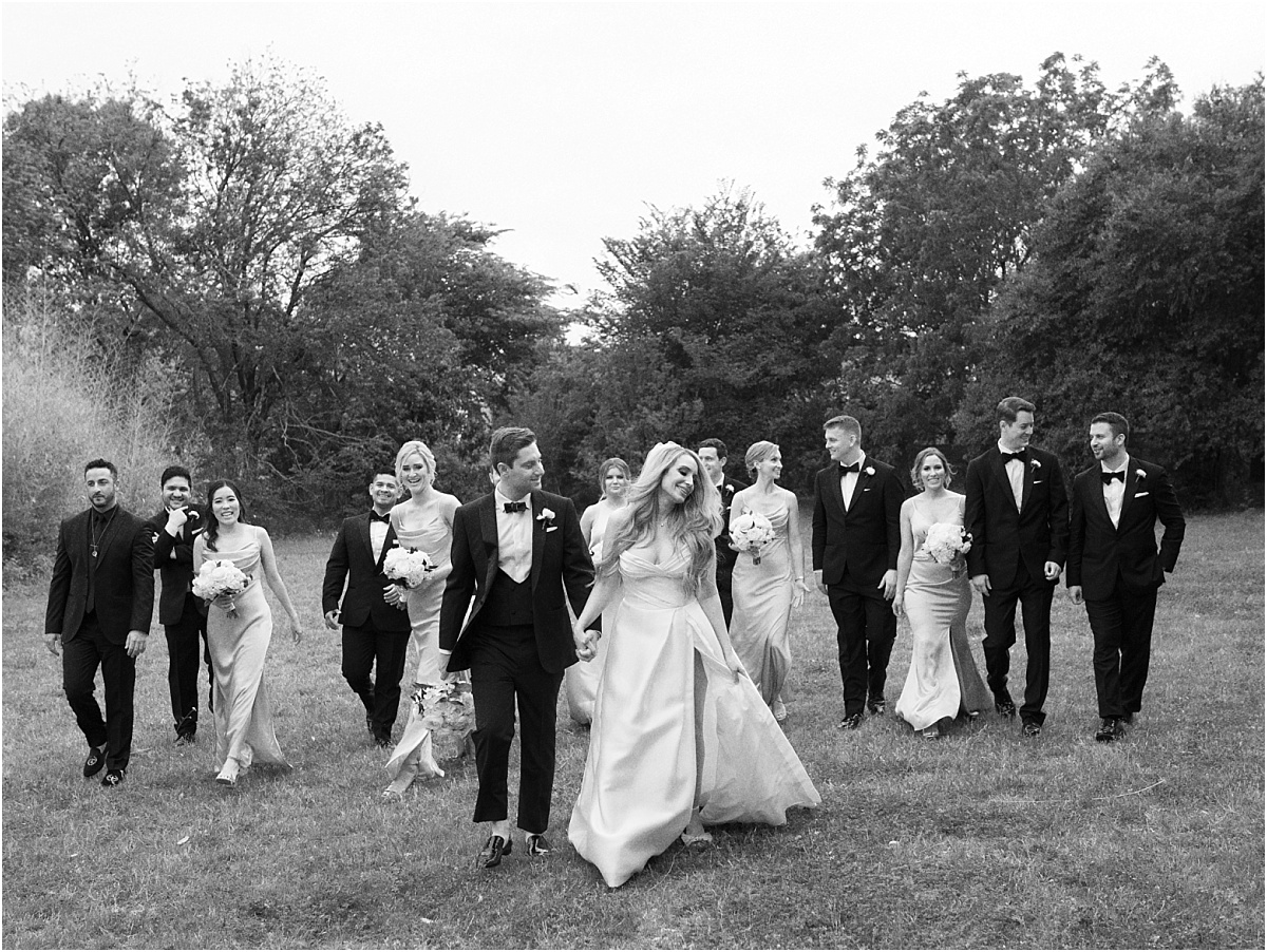 Bridal party walking with bride and Groom.