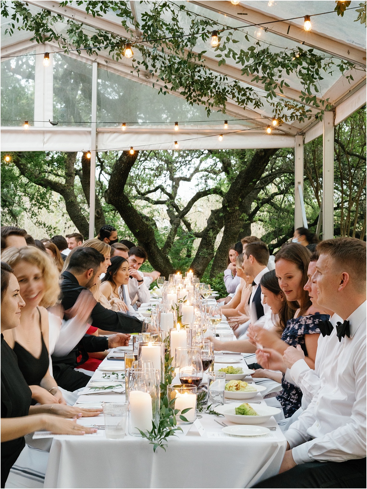 People during an al fresco dinner at a wedding reception. 