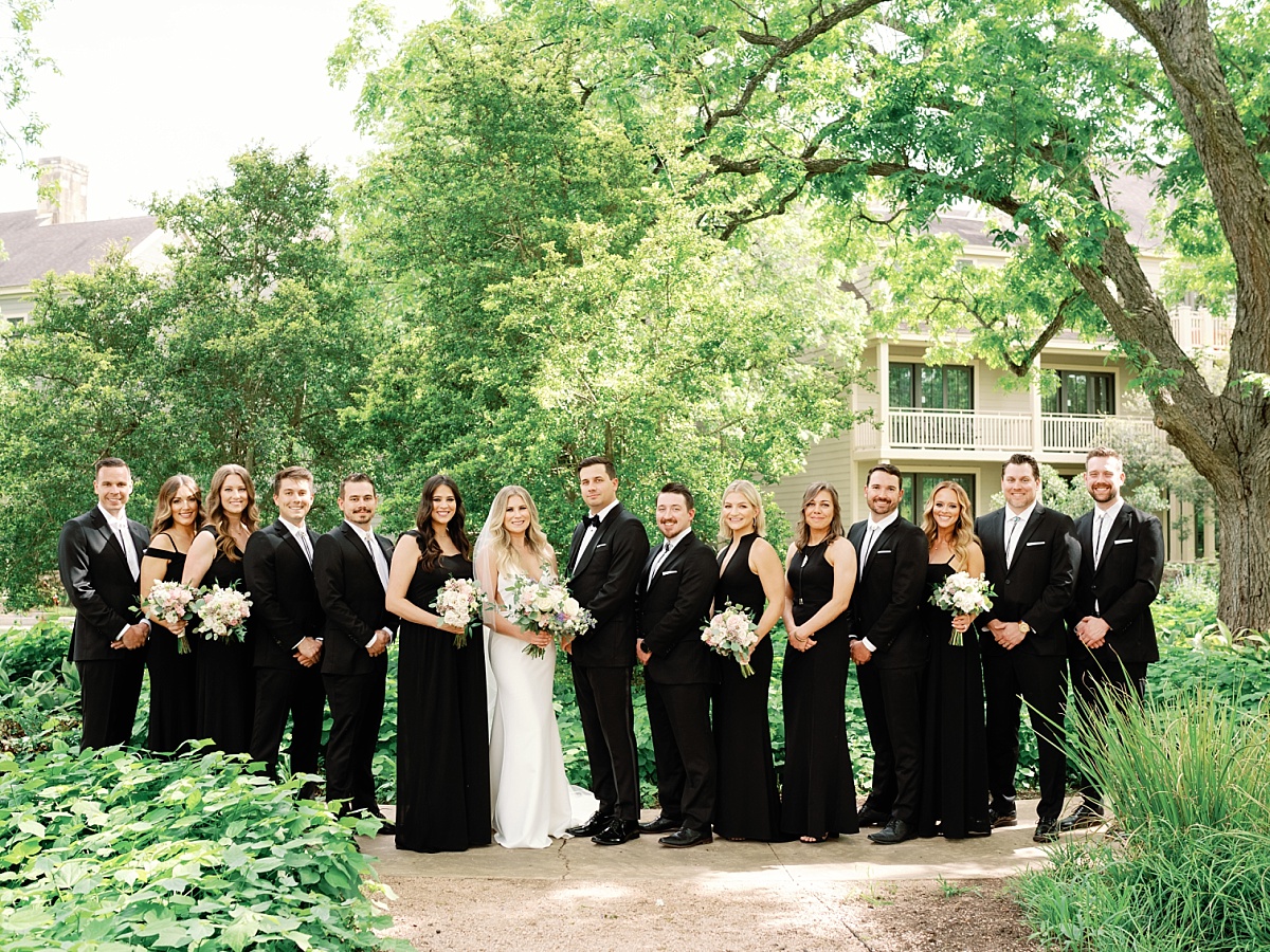 Bridal party with bride and groom on the front lawn at Hyatt Lost Pines.