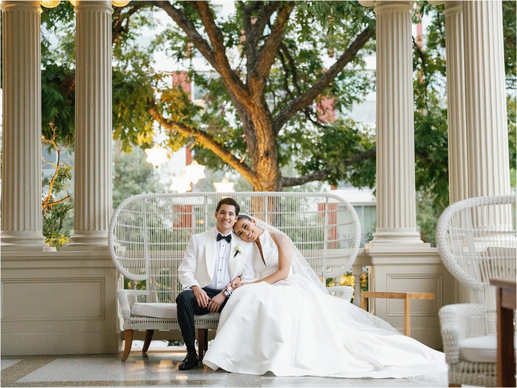 Bride and groom sitting on front porch at Hotel Ella.