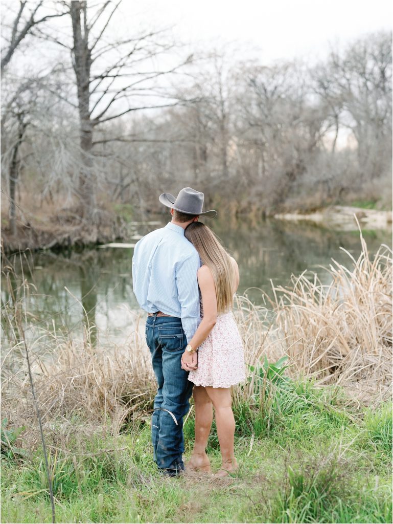 couple embracing at McKinney Falls during engagement session.