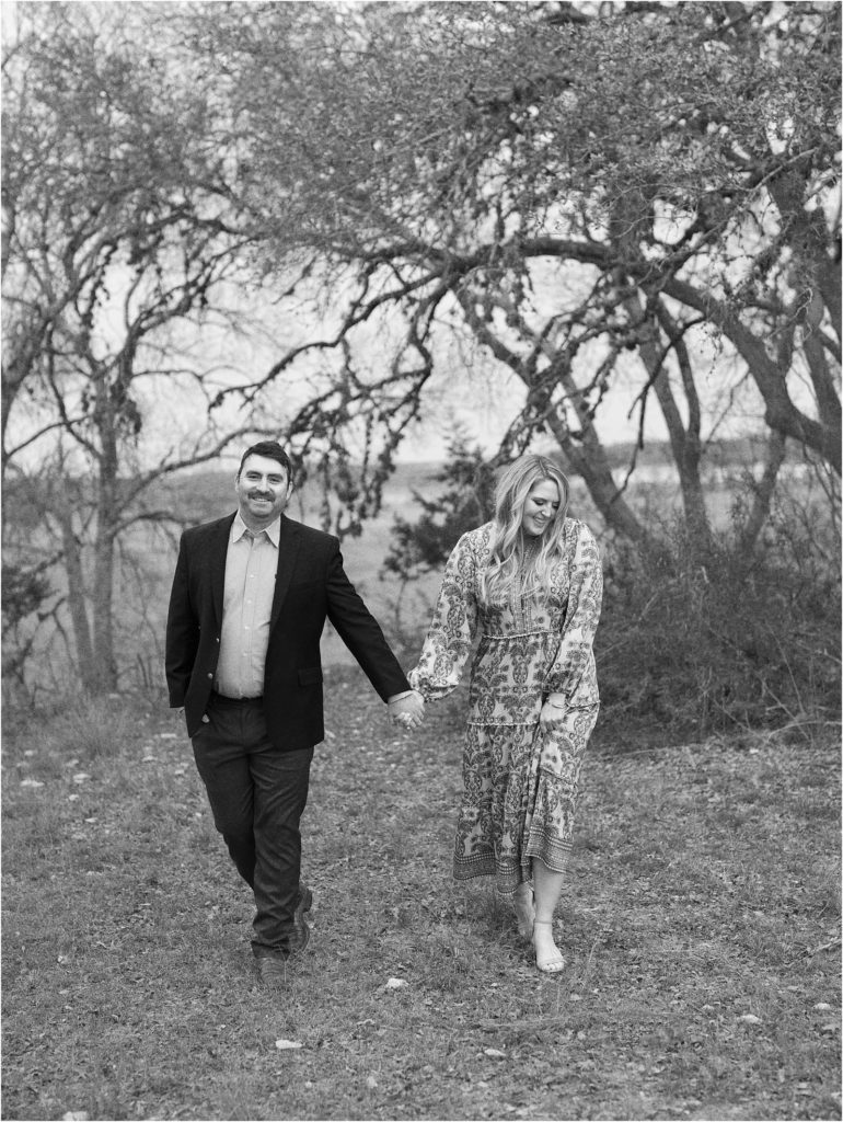 Bride and Groom walking and holding hands in an open field in San Antonio.