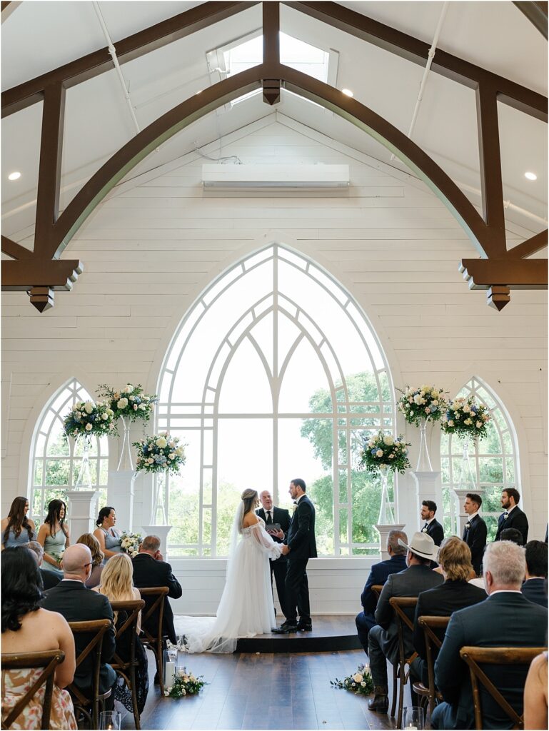 Bride and groom standing at the altar exchanging their vows at HighPointe Estate wedding venue.