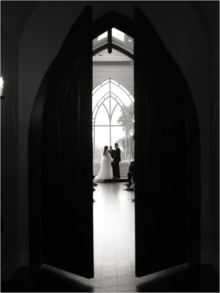 Bride and groom standing at the altar exchanging their vows at HighPointe Estate wedding venue.