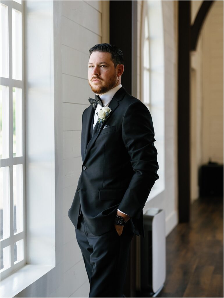 Groom standing in the chapel at HighPointe Estate.