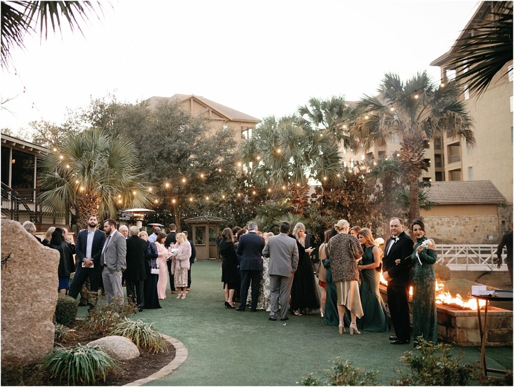 View of the guests mingling on the lawn during cocktail hour at a Horseshoe Bay Resort wedding.