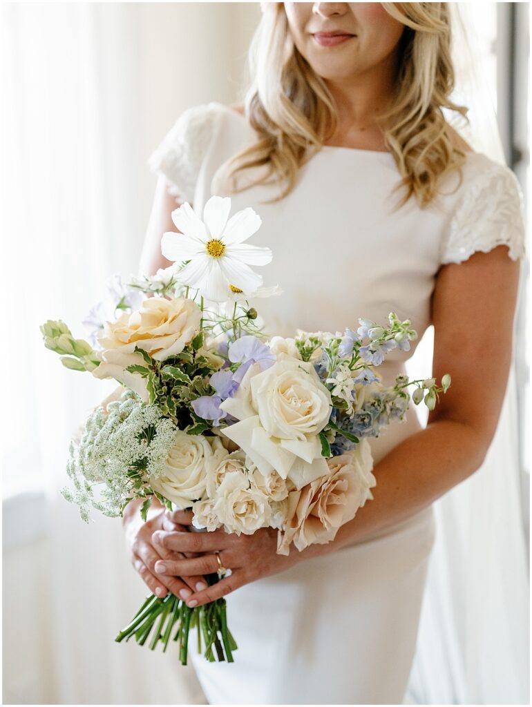 Bride holding her summer wedding bouquet.