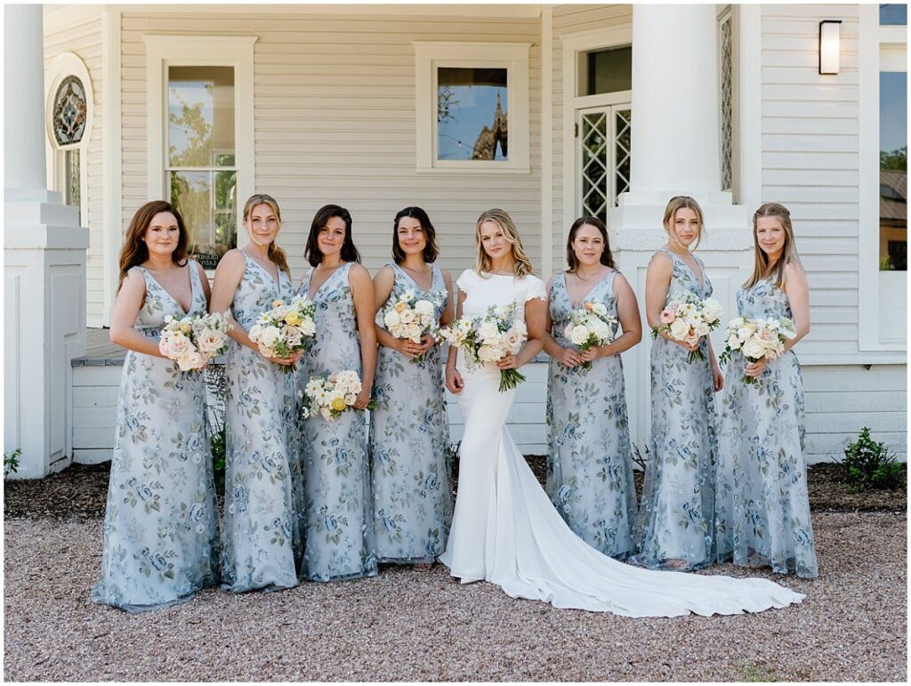 Bride with her bridesmaids in front of the porch at the Grand Lady.