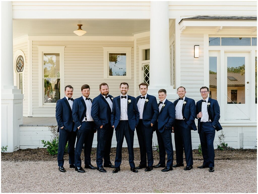 Groom with his groomsmen on the porch at The Grand Lady.
