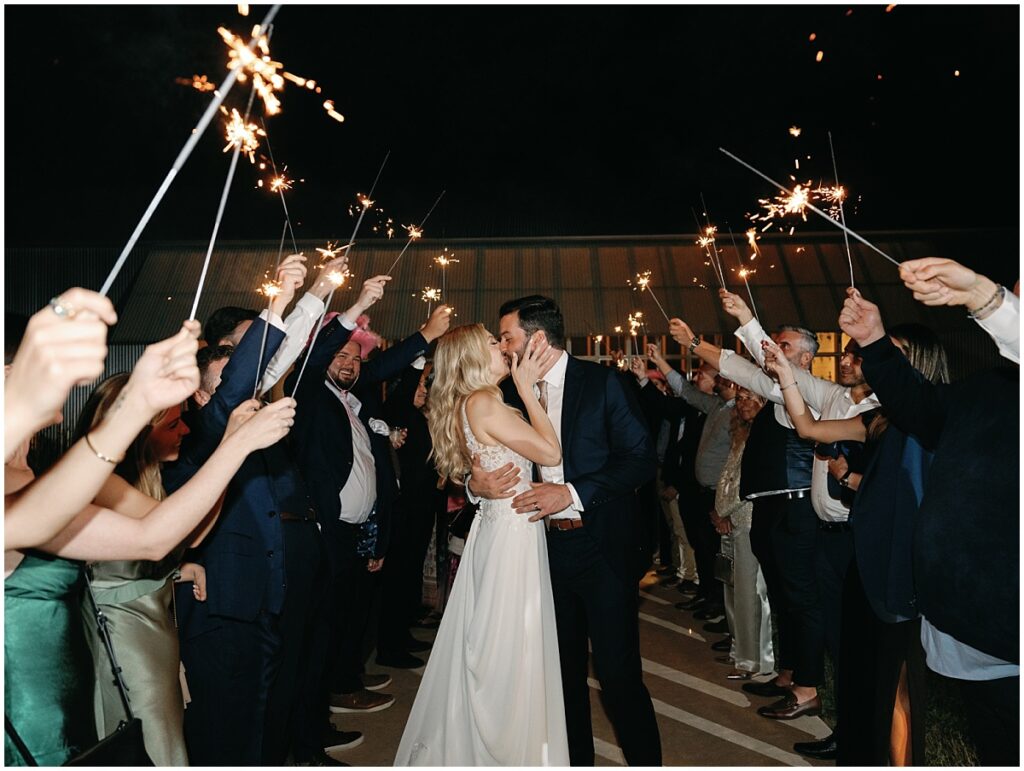 bride and groom kissing in the sparkler exit at the Prospect House.