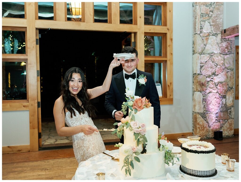 The bride and groom cut their wedding cake together.