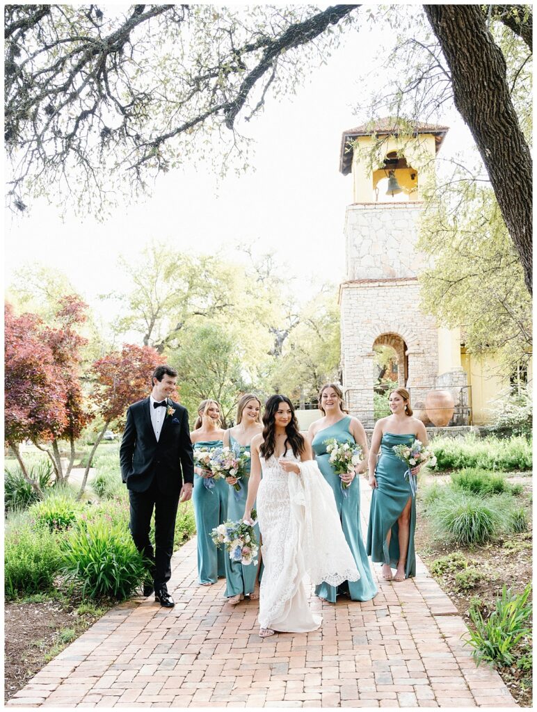 Savana and her bridesmaids walk along the flower-lined path leading to Ian's Chapel, their excitement beautifully captured.