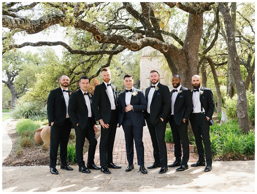 Casey and his groomsmen pose under the ancient oak trees near Ian's Chapel, exuding camaraderie and excitement.