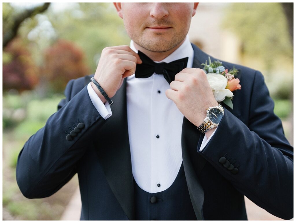 Casey adjusts his tie on the path leading to Ian's Chapel, exuding confidence and excitement for the day ahead.