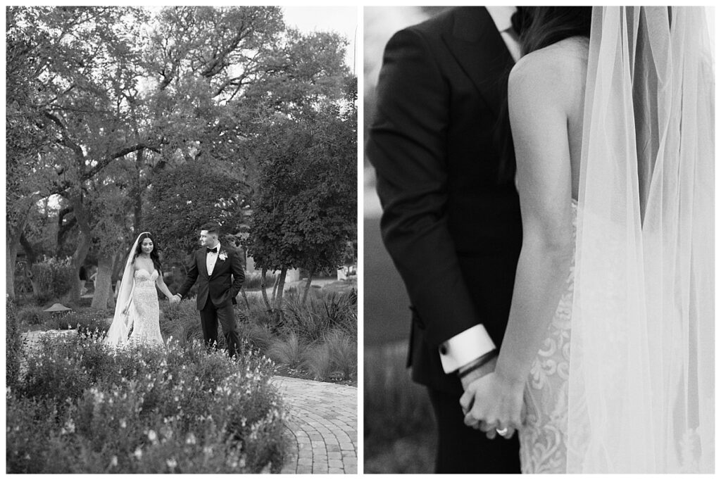 Casey gently holds Savana's hand as they walk along a flower-lined path, with Ian's Chapel visible in the distance at Camp Lucy.